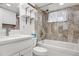Modern bathroom with tub and tiled wall surround, updated vanity and shelving at 5862 Owens St, Arvada, CO 80004