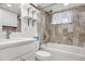 Cozy bathroom with a tiled shower-over-tub and floating shelves for storage at 5862 Owens St, Arvada, CO 80004