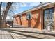 Deck exterior view of brick home with exterior access door at 5862 Owens St, Arvada, CO 80004