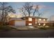 Well-maintained two-story home featuring a brick facade, attached garage and a spacious driveway at 5862 Owens St, Arvada, CO 80004