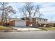 Two-story brick home featuring a two-car garage and a well-maintained lawn at 5862 Owens St, Arvada, CO 80004