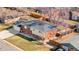 Aerial view of brick home with mature trees, fenced backyard and a detached two-car garage at 5862 Owens St, Arvada, CO 80004