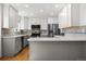 Bright kitchen with gray cabinets, stainless appliances, hardwood floors and tile backsplash at 5862 Owens St, Arvada, CO 80004
