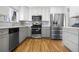 Updated kitchen featuring stainless steel appliances, modern cabinetry and hardwood floors at 5862 Owens St, Arvada, CO 80004