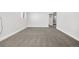 Spacious living room with soft carpet and a clean, neutral color palette and easy access to stairs at 5862 Owens St, Arvada, CO 80004