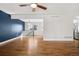 Open concept living room with a hardwood floor, a cozy blue accent wall, and modern fixtures at 5862 Owens St, Arvada, CO 80004