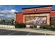 Exterior view of BJ's Restaurant & Brewhouse featuring red facade, mural, and outdoor patio at 14497 E 1St Dr # B3, Aurora, CO 80011