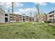 A well-manicured lawn graces the front of this multi-story apartment complex with brick and white siding at 14497 E 1St Dr # B3, Aurora, CO 80011