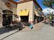 A street view of Fatburger restaurant with outdoor patio seating and colorful awnings on a sunny day at 14497 E 1St Dr # B3, Aurora, CO 80011