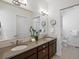 Bathroom featuring double sinks with quartz countertops and updated hardware at 10258 W Coal Mine Pl, Littleton, CO 80127