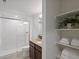 Bathroom featuring a glass-enclosed shower, modern fixtures, and shelving for storage at 10258 W Coal Mine Pl, Littleton, CO 80127
