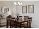 Dining room with modern lighting, abstract artwork, and a dark wood table and chairs at 10258 W Coal Mine Pl, Littleton, CO 80127