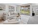 Bright living room featuring a large sliding glass door, light gray walls, and neutral-toned furniture at 10258 W Coal Mine Pl, Littleton, CO 80127