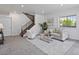 Open-concept living room with stairs, neutral walls, plush seating and modern decor at 10258 W Coal Mine Pl, Littleton, CO 80127