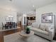 Open floor plan featuring a large living room with white couch leading into a dining room and updated kitchen at 10258 W Coal Mine Pl, Littleton, CO 80127
