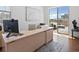 Bright home office with a large desk, natural light, and access to the outdoor deck at 10258 W Coal Mine Pl, Littleton, CO 80127