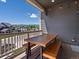 Covered patio with wood table and benches offering an inviting outdoor space for dining and relaxation at 10258 W Coal Mine Pl, Littleton, CO 80127