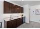 Stylish wet bar featuring granite countertops, custom cabinetry, and a built-in wine cooler at 10258 W Coal Mine Pl, Littleton, CO 80127