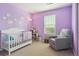 Bright, purple-themed bedroom with plush carpet and chair at 11330 Pacific Peak Ct, Parker, CO 80134