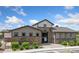 Exterior of a tan and stone clubhouse with a visible address and manicured landscaping at 11330 Pacific Peak Ct, Parker, CO 80134