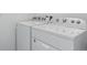 Bright laundry room includes white front load washer and dryer at 11330 Pacific Peak Ct, Parker, CO 80134
