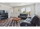Spacious living room with lots of natural light and cozy black sofas at 11330 Pacific Peak Ct, Parker, CO 80134