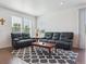 Bright living room featuring comfortable leather sofas and hardwood floors at 11330 Pacific Peak Ct, Parker, CO 80134