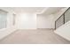 Spacious basement area with carpet flooring, bright lighting, and access to stairs at 2685 S Acoma St, Denver, CO 80223