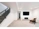 Finished basement with modern staircase, media area, and sleek fireplace at 2685 S Acoma St, Denver, CO 80223