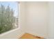 A bedroom featuring a large window, hardwood flooring, and neutral-colored walls offering ample natural light at 2685 S Acoma St, Denver, CO 80223