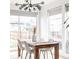 Elegant dining room with modern chandelier and plenty of natural light from large windows at 2685 S Acoma St, Denver, CO 80223