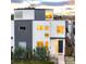 Modern two-story home boasts clean lines and a mix of white stucco and gray metal siding at 2685 S Acoma St, Denver, CO 80223