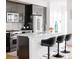 Stylish kitchen has stainless steel appliances, a breakfast bar with seating, and white subway tile backsplash at 2685 S Acoma St, Denver, CO 80223
