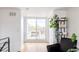 Second story living room with sliders to deck, shelves, and stylish black leather chair at 2685 S Acoma St, Denver, CO 80223