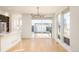 Bright open-concept living space featuring hardwood floors and modern light fixture at 2685 S Acoma St, Denver, CO 80223