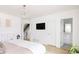 Bright main bedroom with chandelier, hardwood floor and ensuite bathroom at 2685 S Acoma St, Denver, CO 80223