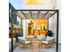 Cozy patio area with a retractable awning, comfortable seating, and outdoor grill at 2685 S Acoma St, Denver, CO 80223