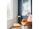 Comfortable sitting area features stylish leather chair and side table next to a window at 2685 S Acoma St, Denver, CO 80223