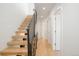 Stylish staircase with wood steps and black metal railing leads to upper levels at 2685 S Acoma St, Denver, CO 80223