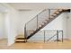 Modern staircase features natural wood treads and an artistic black metal handrail system at 2685 S Acoma St, Denver, CO 80223