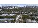 Sweeping aerial view of residential mountain community surrounded by a forest landscape and ski trails at 43 Snowflake Dr # D7, Breckenridge, CO 80424