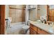 Tiled bathroom featuring a shower-tub combination, vanity with sink, and convenient toilet at 43 Snowflake Dr # D7, Breckenridge, CO 80424