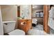 Bathroom featuring a vanity with sink, toilet, and a view into the bedroom at 43 Snowflake Dr # D7, Breckenridge, CO 80424