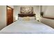 Bright bedroom featuring a large bed with white linens, decorative art, and bedside lamps at 43 Snowflake Dr # D7, Breckenridge, CO 80424