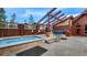 Hot tub area with a cedar pergola, natural stone accents, and community pool at 43 Snowflake Dr # D7, Breckenridge, CO 80424