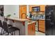 Well-equipped kitchen with stainless steel appliances and breakfast bar at 43 Snowflake Dr # D7, Breckenridge, CO 80424