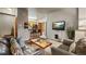 Open concept living space with kitchen bar, mounted TV, and comfortable seating at 43 Snowflake Dr # D7, Breckenridge, CO 80424