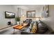 Cozy living room featuring stylish furniture, mounted TV, and a window at 43 Snowflake Dr # D7, Breckenridge, CO 80424