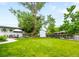 Large grassy backyard, featuring a patio area and a white storage shed at 7695 S Sheridan Ct, Littleton, CO 80128