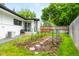 Charming backyard garden space with lush greenery, stone pathway, and wooden fence, perfect for gardening enthusiasts at 7695 S Sheridan Ct, Littleton, CO 80128